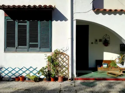a white house with a balcony on top of it at B&B Ondamarina in Lascari