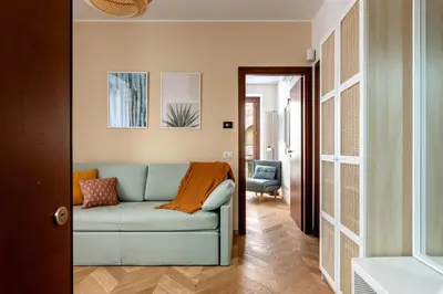 a living room with a blue couch and a chair at Casa Dolce Vita by Wonderful Italy in Palermo