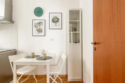 a table and chairs in a kitchen with a clock on the wall at Casa Dolce Vita by Wonderful Italy in Palermo