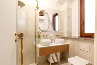 a bathroom with two sinks and a toilet at Casa Dolce Vita by Wonderful Italy in Palermo