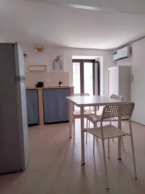 a kitchen with a table and chairs in a room at Casa Nadir in Palermo