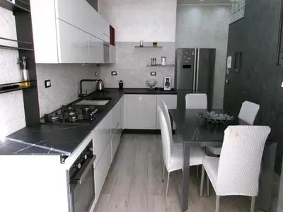 a kitchen with a table and chairs and a refrigerator at Antadia Terminal Bus in Palermo
