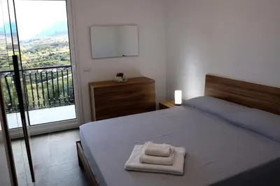 a bedroom with a bed with two towels on it at Trabia Casa Bianca B in Mandra Capreria