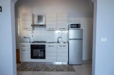 a kitchen with a white refrigerator and a sink at Trabia Villa Bedda Mia B in Trabia