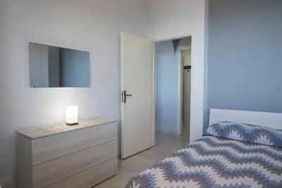a bedroom with a bed and a dresser with a mirror at Trabia Villa Bedda Mia B in Trabia