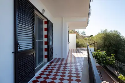 a house with a checkered floor in front of a door at Trabia Villa Bedda Mia B in Trabia