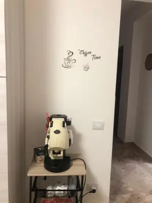 a white wall with a sewing machine on a table at Casa Sulia in Terrasini