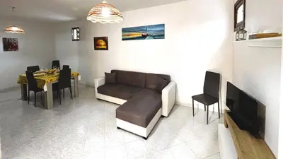 a living room with a couch and a table at Casa Amodei 1 a pochi passi dal mare in San Vito lo Capo