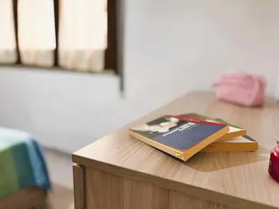 a book sitting on top of a wooden table at Casa Amodei 1 a pochi passi dal mare in San Vito lo Capo