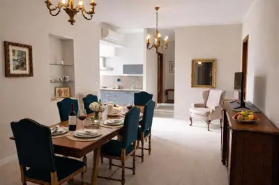 a dining room and living room with a table and chairs at CapoMassimo in Palermo