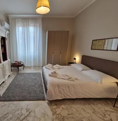 a bedroom with a large bed with towels on it at CapoMassimo in Palermo