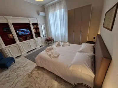 a bedroom with a large bed with towels on it at CapoMassimo in Palermo
