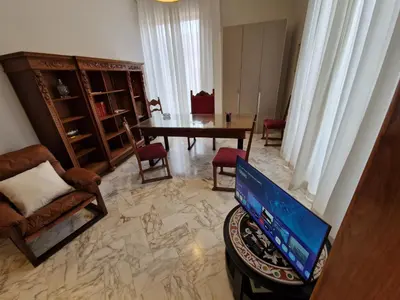 a living room with a television and a table at CapoMassimo in Palermo