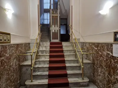 a staircase in a building with a red and black carpet at CapoMassimo in Palermo