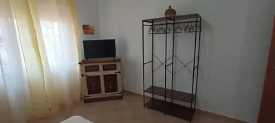 a living room with a television and a tv stand at Villa Alba in Palermo