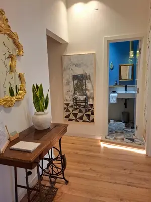 a living room with a table and a mirror at MAGGESE Dimora di Charme in Palermo