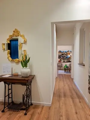 a hallway with a table and a mirror on the wall at MAGGESE Dimora di Charme in Palermo
