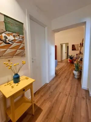 a living room with a table and a painting on the wall at MAGGESE Dimora di Charme in Palermo