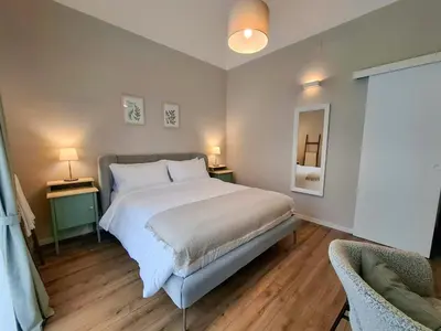 a bedroom with a bed and two tables and two lamps at MAGGESE Dimora di Charme in Palermo