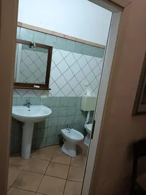 a bathroom with a sink and a toilet at Casale di Riena in Lercara Friddi