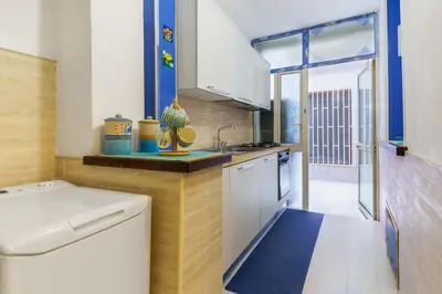 a kitchen with a sink and a counter top at Ruci ruci in Mondello