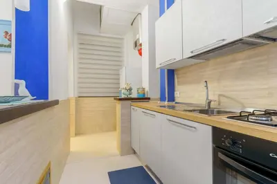 a kitchen with white cabinets and a sink at Ruci ruci in Mondello
