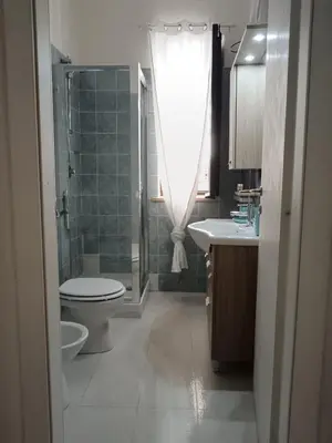 a bathroom with a toilet and a shower and a sink at Ruci ruci in Mondello