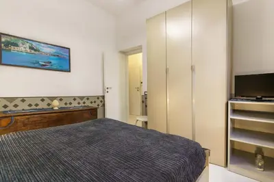 a bedroom with a bed and a flat screen tv at Ruci ruci in Mondello