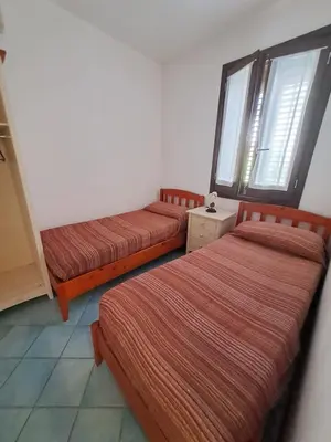a room with three beds and a window at Casa Tonnarella San Vito Lo Capo in San Vito lo Capo