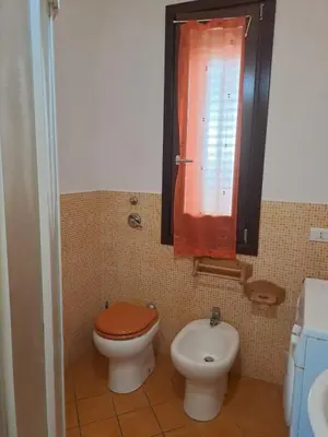 a bathroom with a toilet and a bidet and a window at Casa Tonnarella San Vito Lo Capo in San Vito lo Capo