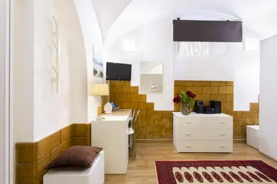 a living room with a table and a desk at Palermo Central Holiday in Palermo