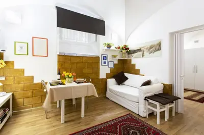 a living room with a white couch and a table at Palermo Central Holiday in Palermo