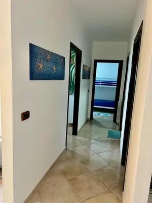 a hallway with two doors and a tile floor at Casa Yasmine in Santa Flavia