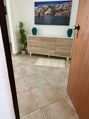 a room with a cabinet and a tile floor at Casa Yasmine in Santa Flavia