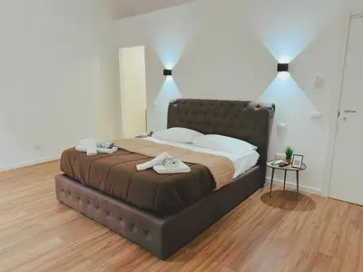 a bedroom with a large bed with two towels on it at Candalù - Palermo Suite in Palermo