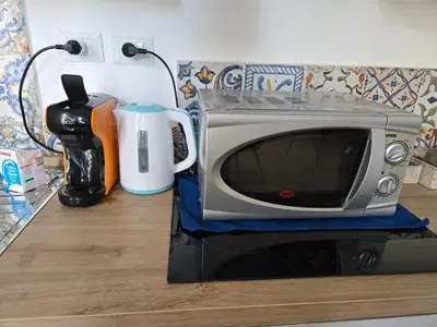 a toaster oven sitting on top of a counter at Candalù - Palermo Suite in Palermo