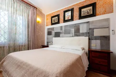 a bedroom with a white bed and a window at Gulliver's Nest in Castellammare del Golfo