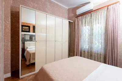 a bedroom with a bed and a large mirror at Gulliver's Nest in Castellammare del Golfo