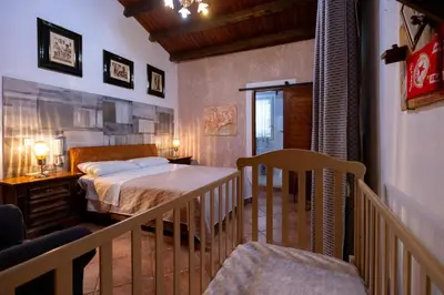 a small bedroom with a bed and a balcony at Gulliver's Nest in Castellammare del Golfo
