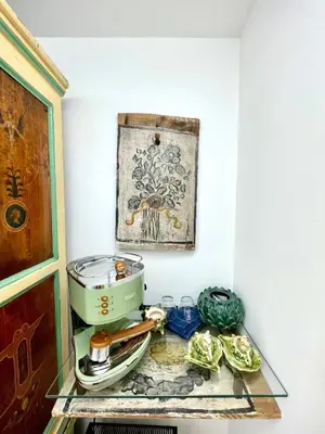 a glass shelf with a slow cooker and vegetables on it at Bella Kalsa in Palermo