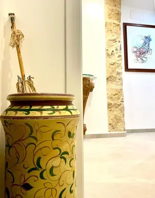 a large vase with a skeleton on it in a museum at Bella Kalsa in Palermo