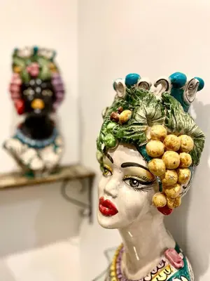 a statue of a woman with fruit on her head at Bella Kalsa in Palermo