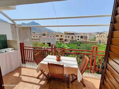 a table and chairs on a balcony with a view at Katia Home - San Vito lo Capo in San Vito lo Capo