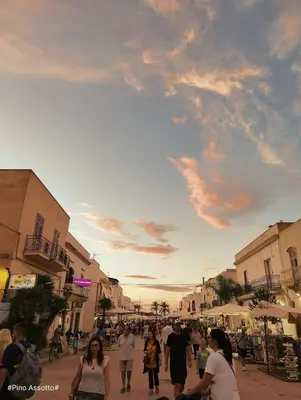 a group of people walking down a street at Katia Home - San Vito lo Capo in San Vito lo Capo