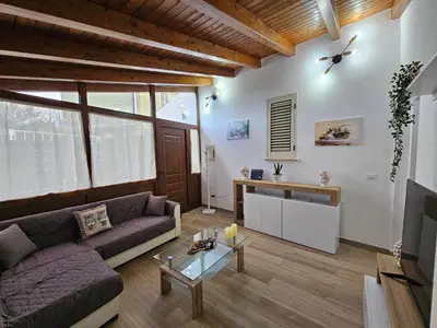 a living room with a couch and a table at la casetta del baglio in Monreale