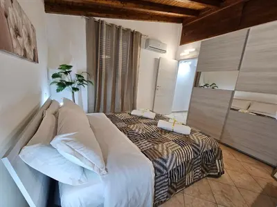 a bedroom with a large bed in a room at la casetta del baglio in Monreale