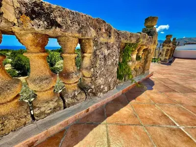 a stone wall with a view of the ocean at History and Art Casa Bellacera in Casteldaccia
