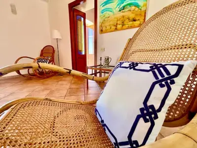 a pillow sitting on a chair in a living room at History and Art Casa Bellacera in Casteldaccia