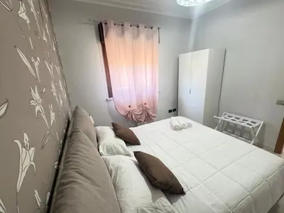 a bed in a room with a couch and a window at Casa Ponticello in Termini Imerese