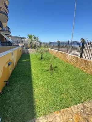 a yard with a fence and some grass at Casa Ponticello in Termini Imerese